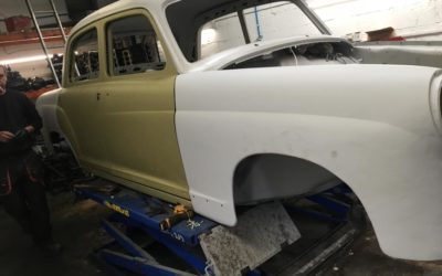 Old car restoration. Body workshop and car body painting, wheels renewing.